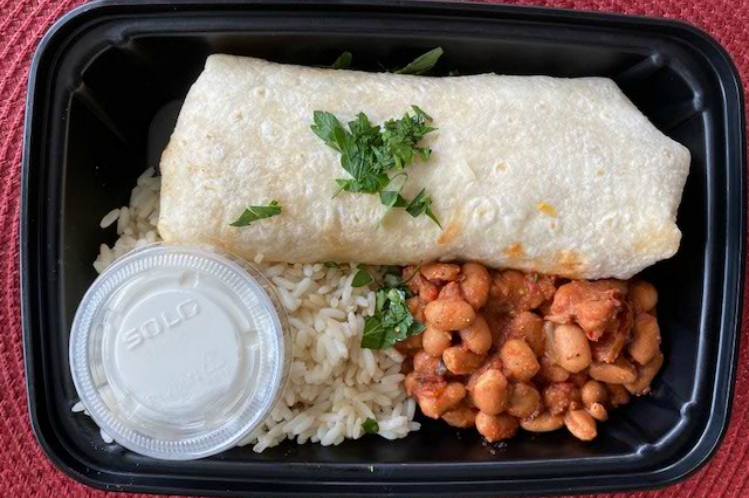 Steak burrito in a flour tortilla served with white rice and smoky cowboy beans.