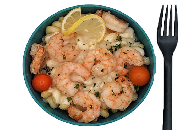 Grilled shrimp alfredo pasta bowl with creamy parmesan sauce and roasted cherry tomatoes